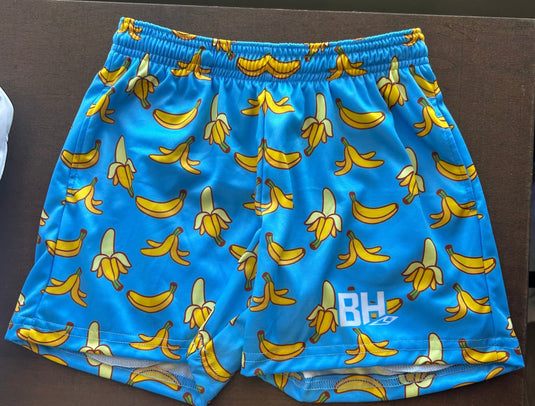 Go bananas on and off the field! These wild blue shorts are covered in playful banana prints for serious fun and fruity flair. Rock 'em when you're peeling out past the competition!

